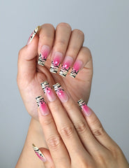 Close-up of Naillover’s handmade Singapore nails featuring a blend of pastel pink and animal print graphics