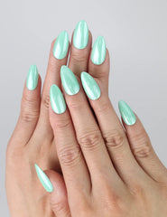 Hand with glossy pastel green almond nails, evoking a soft and tranquil spring mood