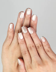 Model wearing NailLover Frosted Glare silver cat eye press on nails under natural light