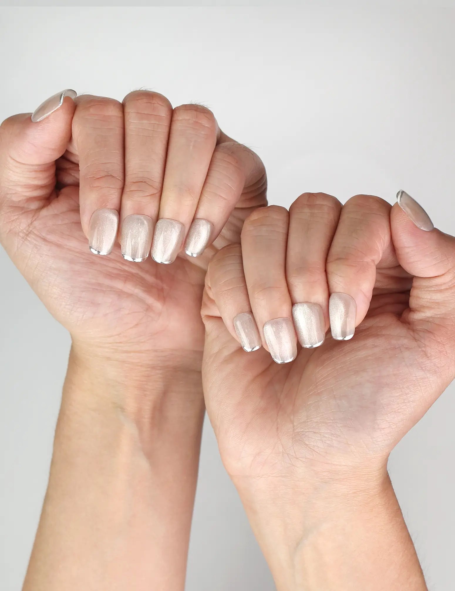 Stylish Singapore press on nails look featuring NailLover Frosted Glare shimmering silver cat eye nails