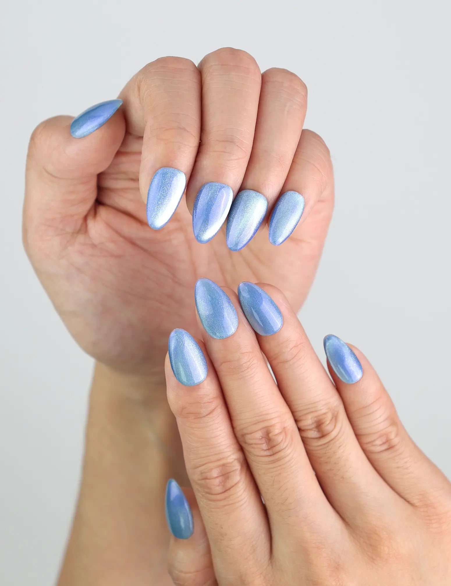 Close-up of Frosted Skyline handmade almond nails, glowing with cool-toned shimmer by Naillover.