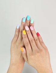 Model wearing Fruit Punch handmade Singapore press on nails in bright fruity colors – close-up view