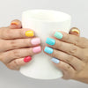 Woman holding a coffee cup wearing Fruit Punch Singapore press on nails by Naillover in juicy summer shades