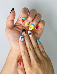 Close-up of Naillover’s Singapore-made press-on nails featuring groovy floral patterns and cheerful emoji details