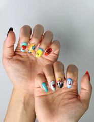 Side view of cute short nails with colorful peace symbols, 70s-style flowers, and pastel emoji art