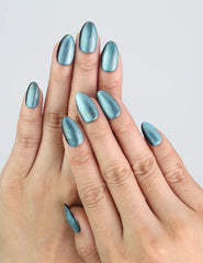 Model wearing Naillover Galaxy Gleam press on nails, shimmering blue galaxy design.