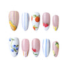 Product display of Naillover’s handmade press-on nail set with pink background and summer-inspired floral and fruit themes