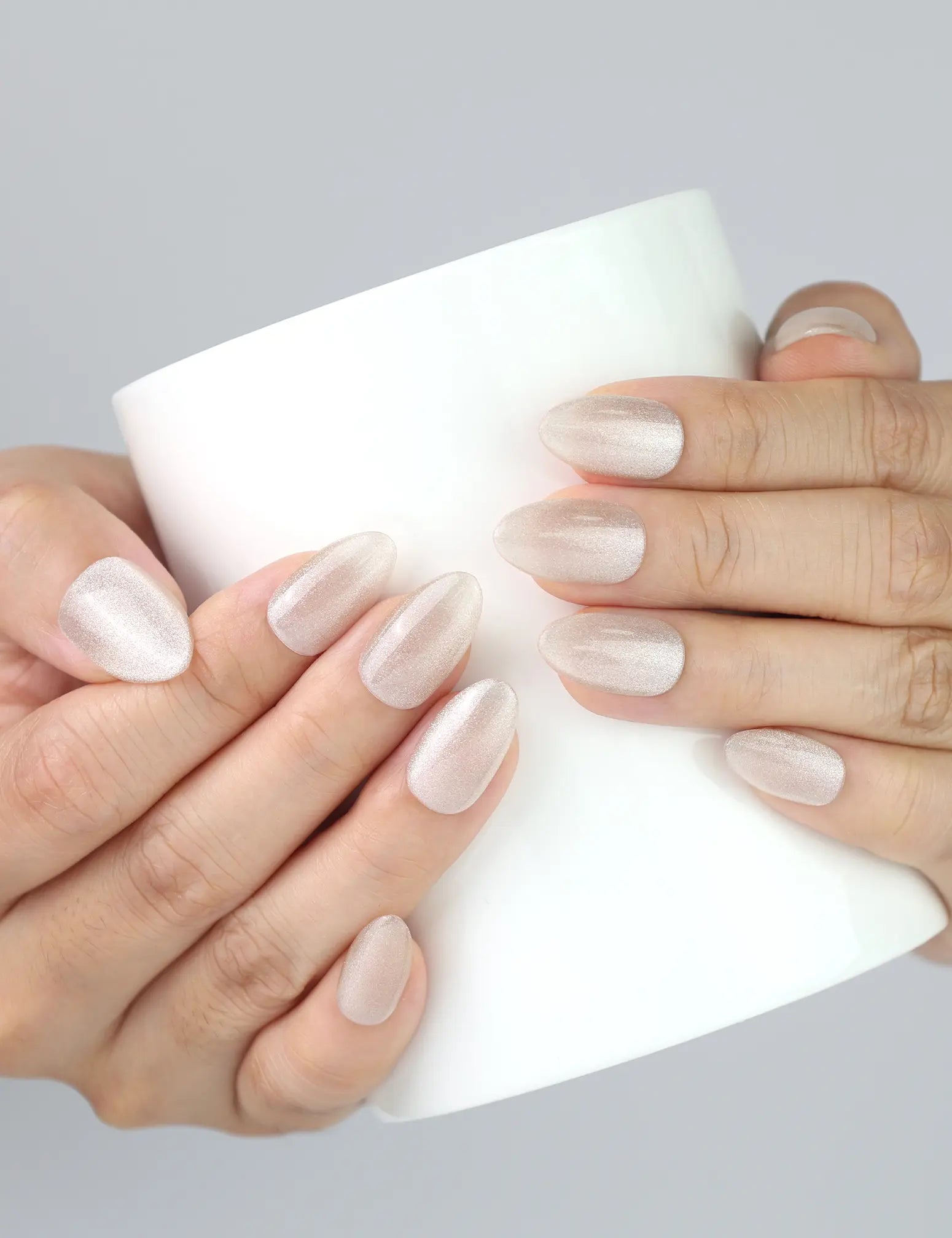 Naillover Glimmer Dust nails holding a coffee cup, showcasing handmade shimmer details in a casual lifestyle setting.