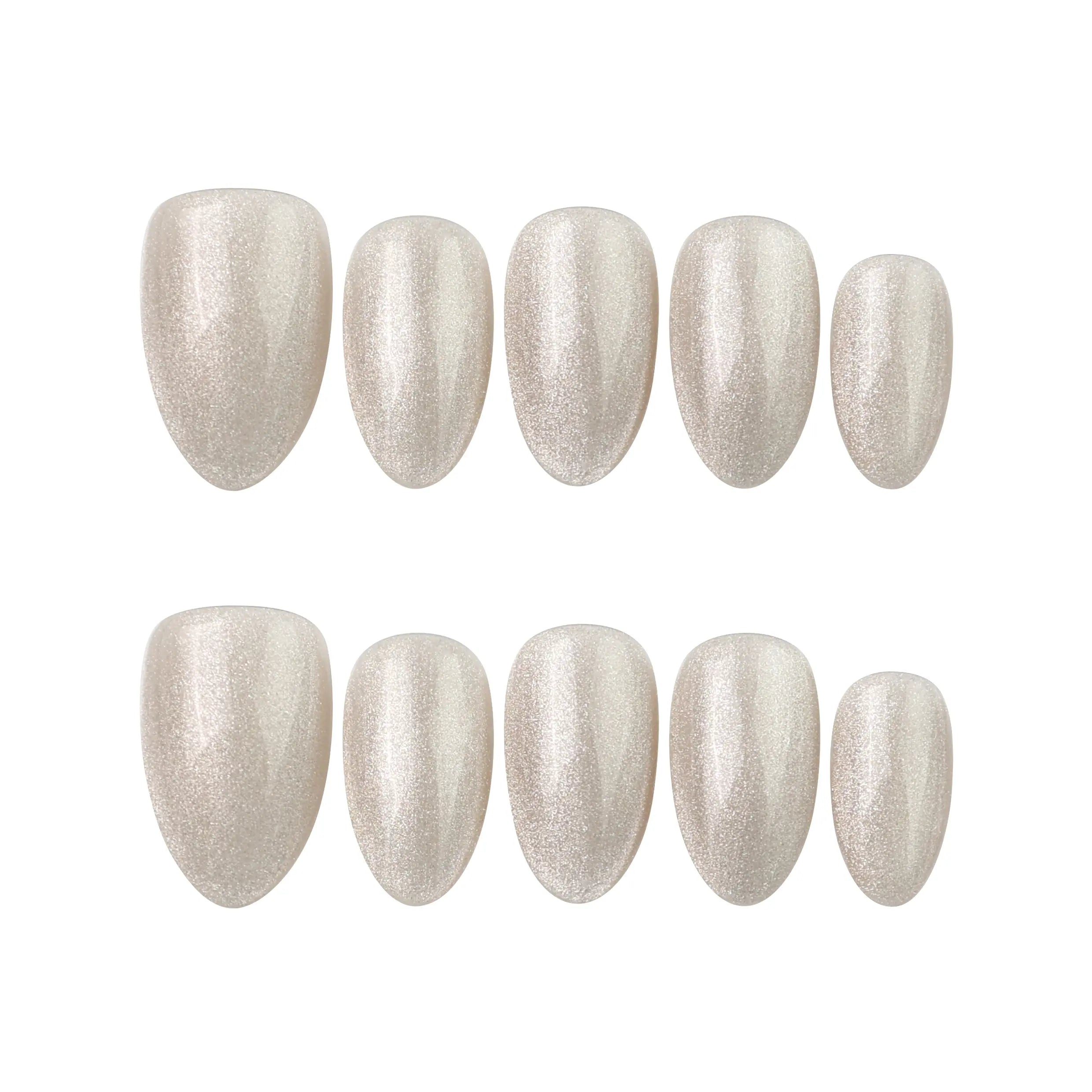 Glimmer Dust short almond press on nails arranged on white background, featuring golden shimmer and soft geometric designs.