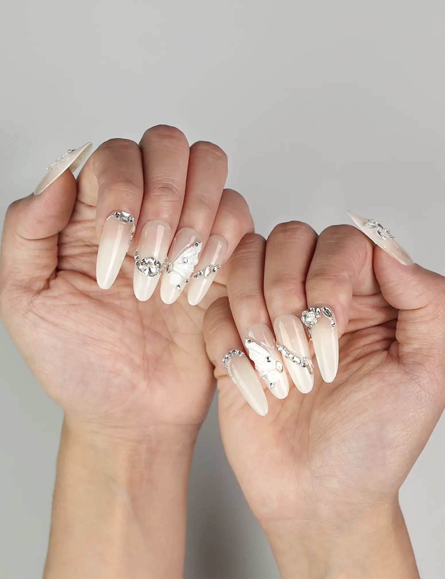 Elegant Glimmer Mirage translucent handmade Singapore press-on nails with silver glitter and butterfly designs by naillover