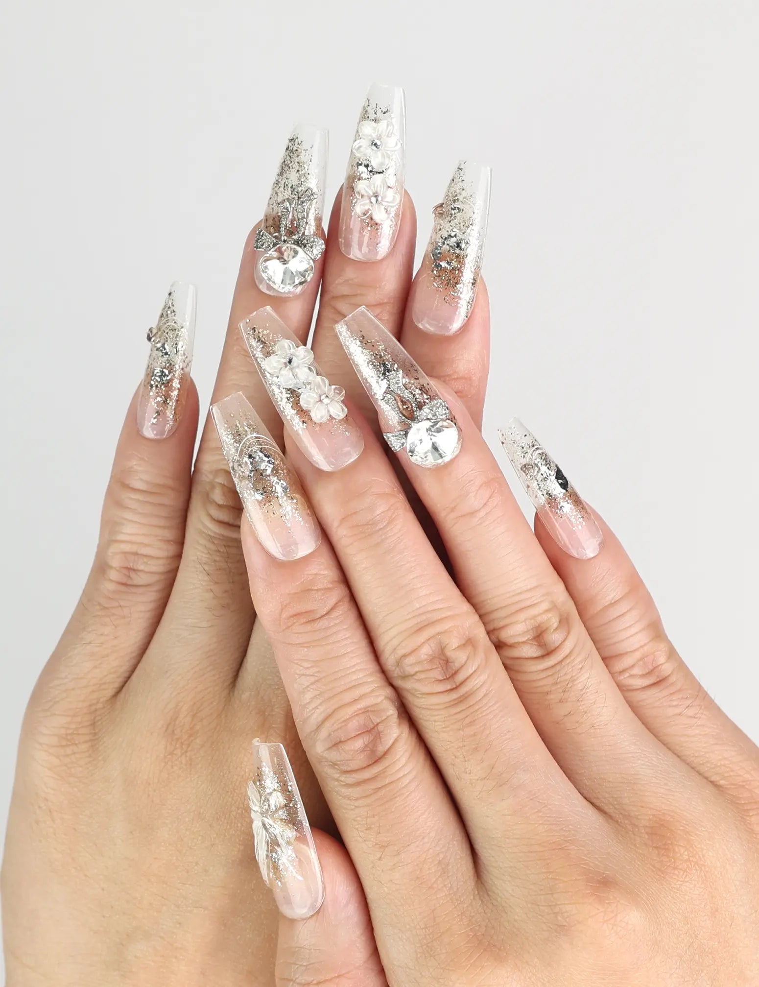 Model wearing Glisten Dream handmade Singapore press on nails with silver glitter and embellishments by naillover