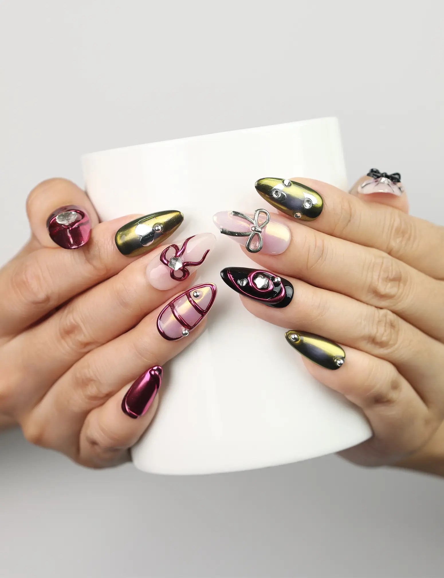 Hand holding coffee cup wearing Glossy Love coquette nails, handmade Singapore press on nails by Naillover.