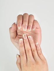Hand wearing Glossy Pink Singapore press on nails in bronze-pink with gold foil accents, handmade by naillover