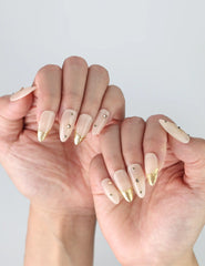 Side view of nude and gold almond press-on nails from Naillover’s Singapore collection, glossy and minimalist