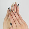 Model wearing Gold Tips Singapore press on nails with nude base and gold pearl accents – handmade by naillover