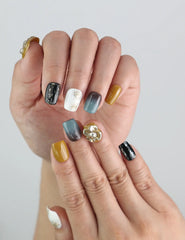 Close-up of Golden Bloom handmade press on nails by Naillover, highlighting the short coffin shape and intricate flower art.