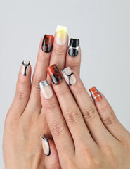 Hand gesture showing short square press on nails with glossy gold finish and caramel marble accents by Naillover
