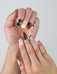 Close-up of fingers posed with golden caramel marble gradient nails in a polished square shape by Naillover
