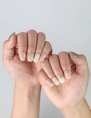 Close-up of hands with Singapore handmade press on nails in pale pink, accented with delicate gold lines and gentle sparkle