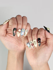 Close-up of hand wearing Gothic Blossoms handmade Singapore press on nails with black and silver floral and heart designs by naillover