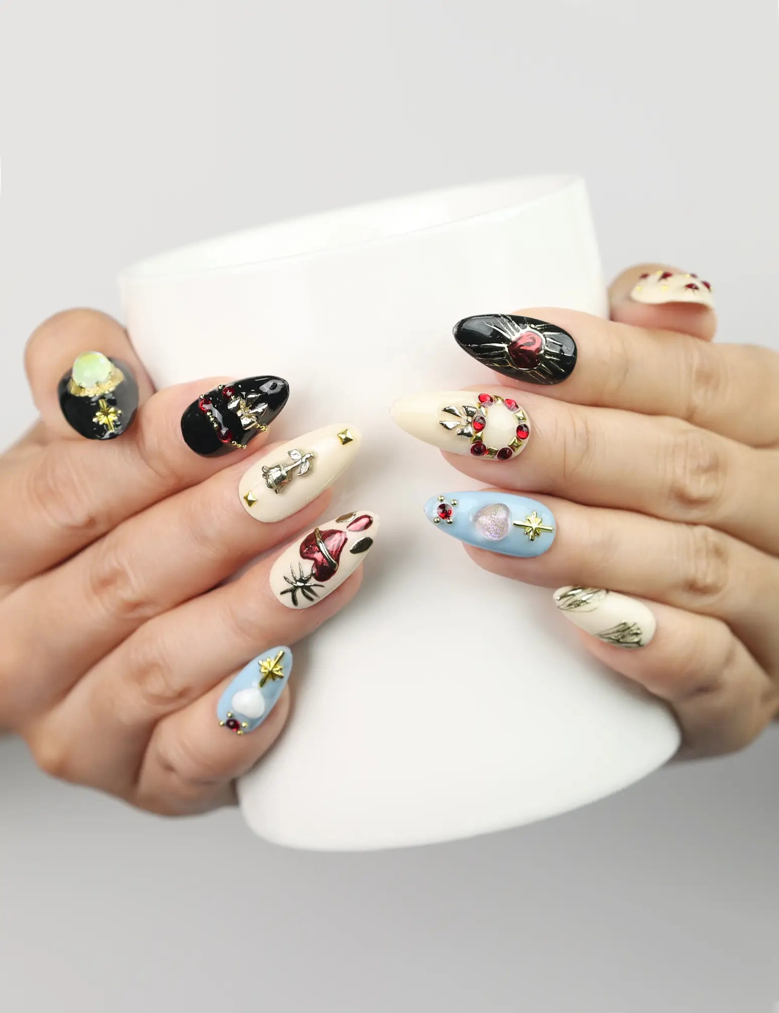 Model holding a cup while wearing Gothic Blossoms handmade Singapore press on nails, featuring black and silver floral and rhinestone accents by naillover