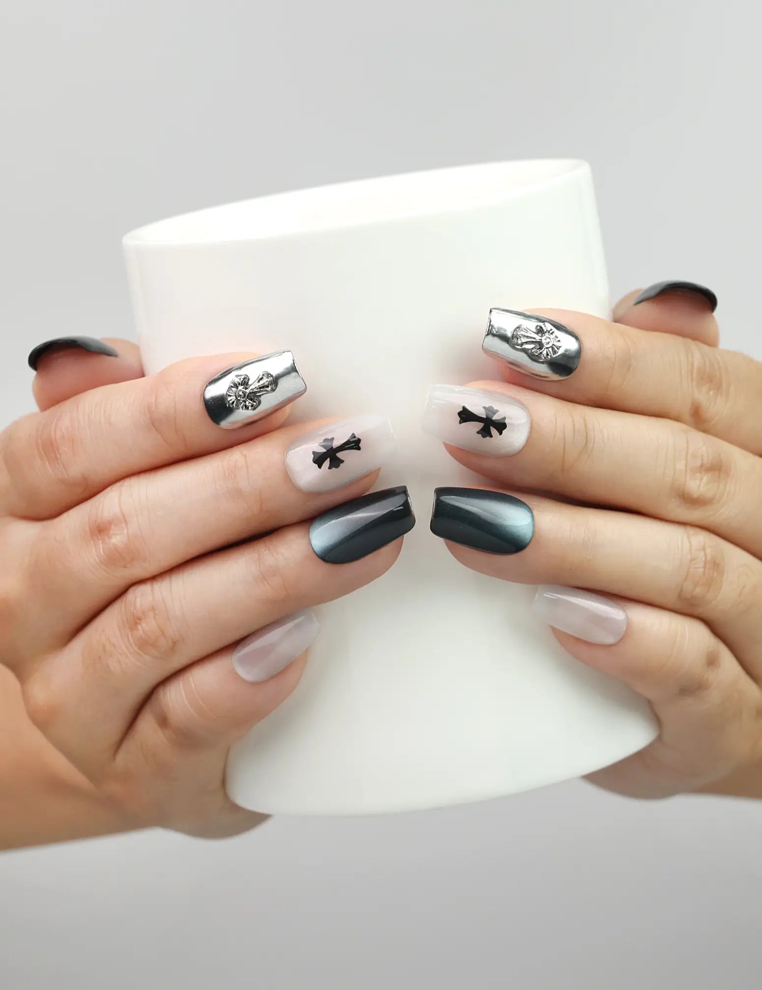 Gothic Cross cat eye handmade press on nails by NailLover, styled while holding a cup for casual chic look