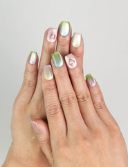 Model wearing Gradient Heart handmade press on nails with pastel gradient and glossy finish, coquette nails look