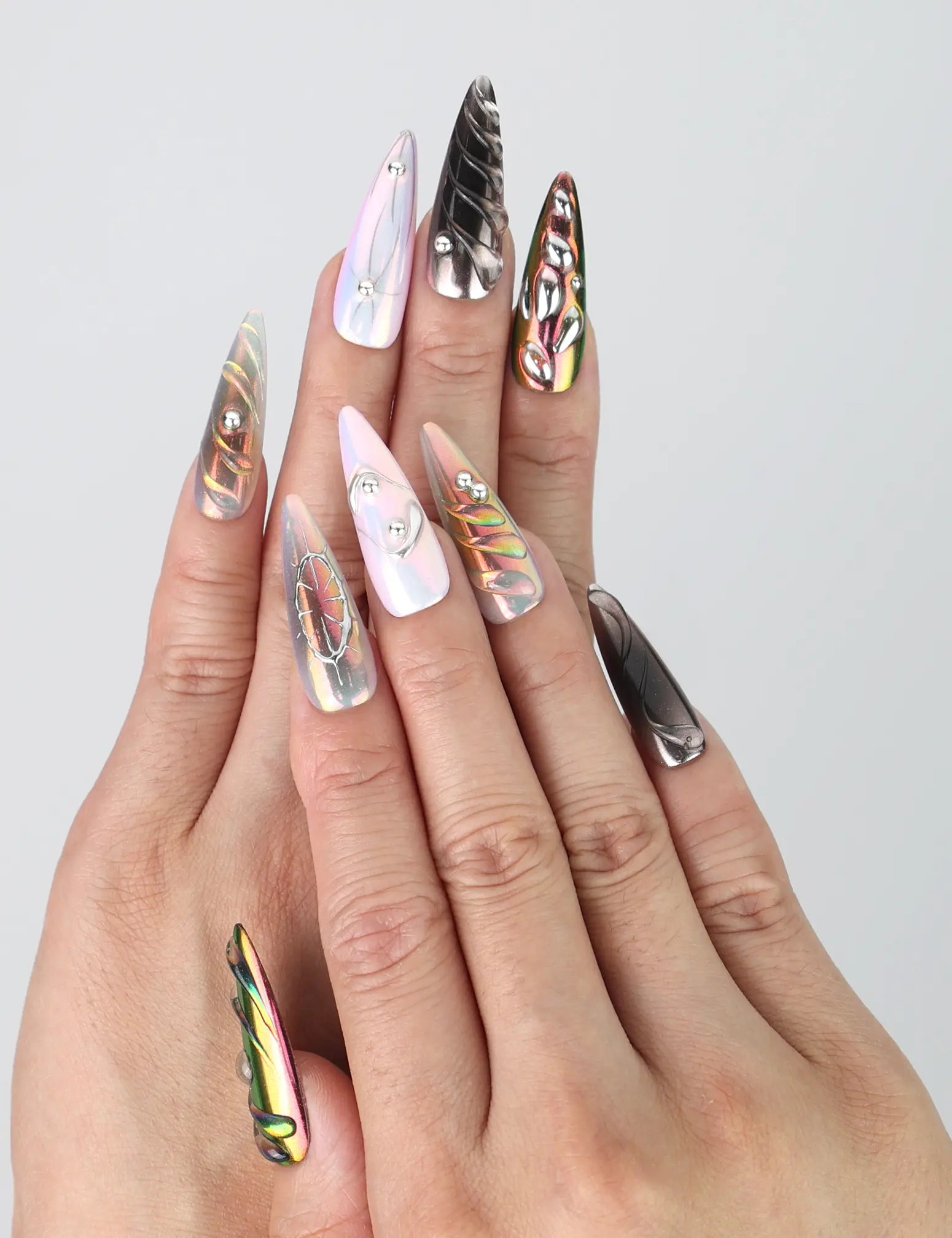 Hand gesture featuring Singapore handmade stiletto press on nails with multicolor chrome finish and embedded gem accents by Naillover