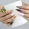 Hand holding a cup while wearing vivid multicolor chrome stiletto nails with embedded gems for a glam touch