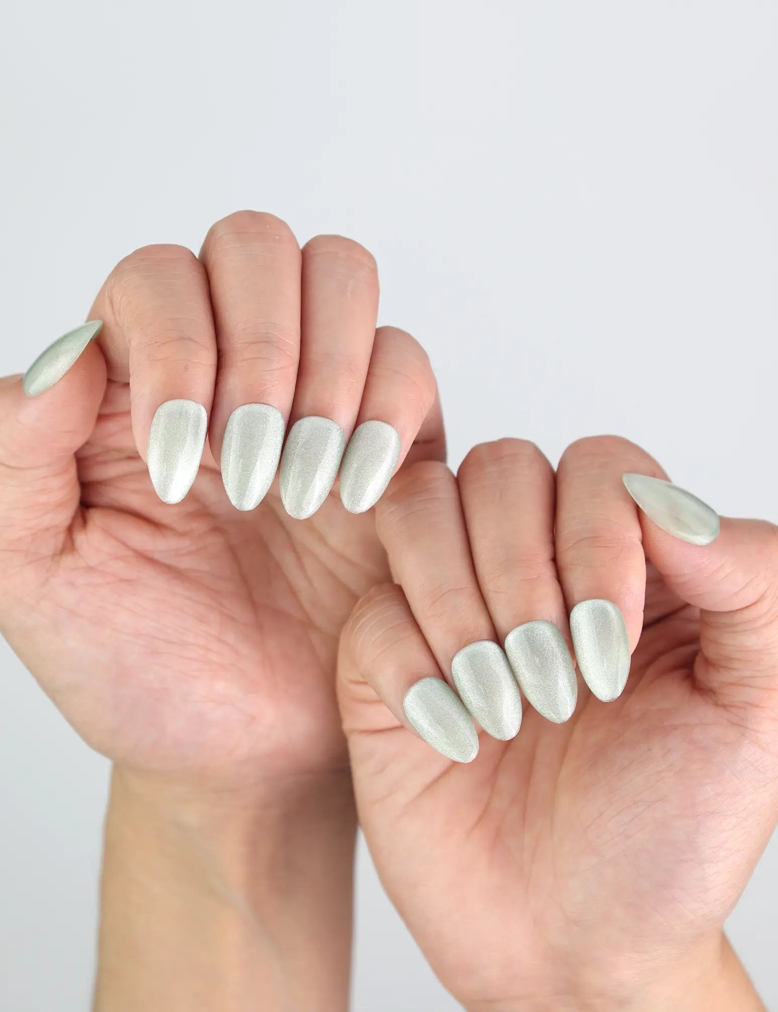 Side view of hands styled with Jade Curve press on nails by Naillover, perfect blend of nature and elegance.