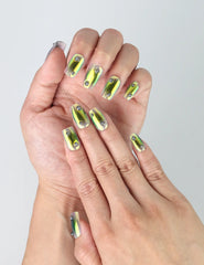 Close-up of Naillover’s green chrome square nails reflecting metallic light with a futuristic mirror finish
