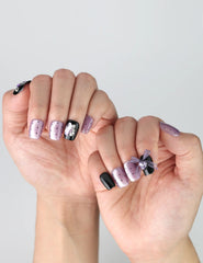 Side view of handmade square press-on nails in deep purple and black with glossy finish and charming kawaii elements