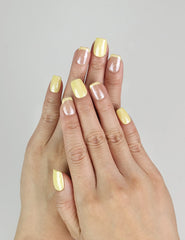 Close-up of Lemon Zest Singapore press on nails on hand, yellow to pink ombre summer nail design by naillover