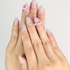 Hand wearing Naillover Lilac Whisper Singapore press on nails with beige base and lavender ribbon accents