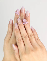 Hand wearing Naillover Lilac Whisper Singapore press on nails with beige base and lavender ribbon accents