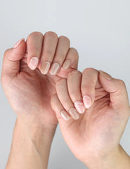Casual hand pose wearing Naillover Singapore press on nails in pink and white marble for everyday elegance.