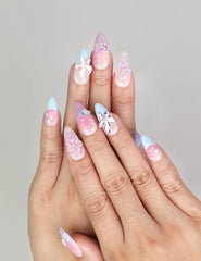 Hand model wearing Naillover Mermaid’s Floral Dream handmade press on nails in pink and blue with 3D floral accents, trendy nails Singapore.