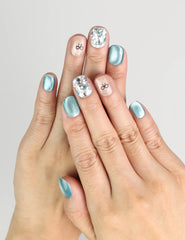 Hand wearing Mint Frost blue shimmer handmade press on nails with crystal accents and bow, naillover Singapore