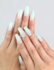 Hand wearing Naillover Misty Blue Fade coffin nails, showcasing gradient from misty grey to soft blue.