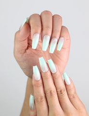 Model styling Misty Blue Fade long coffin press on nails by Naillover, ideal for a minimalist winter look.