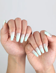 Close-up of Naillover Misty Blue Fade Singapore press on nails worn on hand, elegant ombré design in focus.