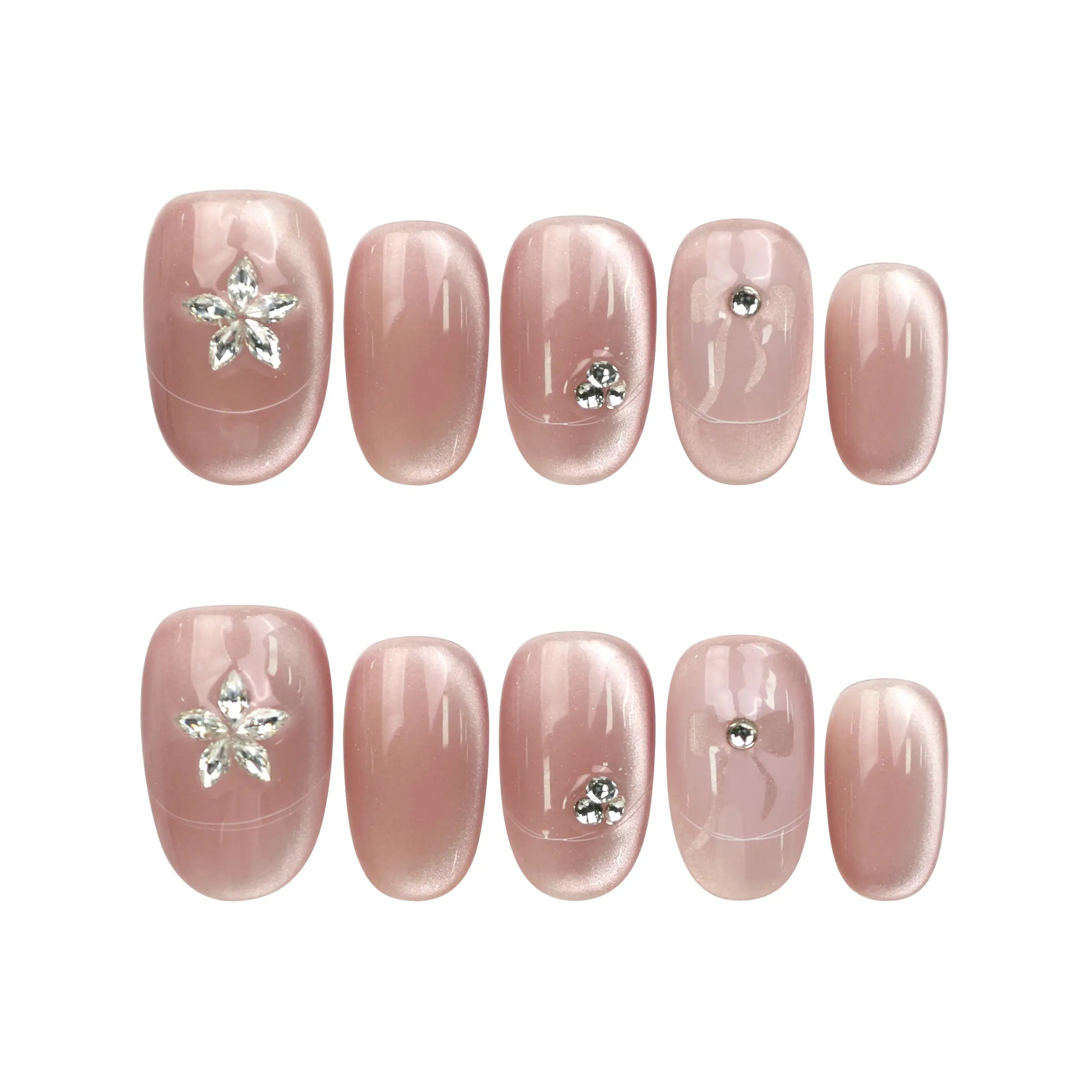 Flat lay of Naillover Misty Rose Singapore press on nails set, featuring handmade nails with cat eye effect and silver details.