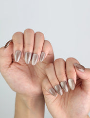 Model styling Naillover Mocha Gleam handmade press on nails, elegant and neutral cat eye finish.