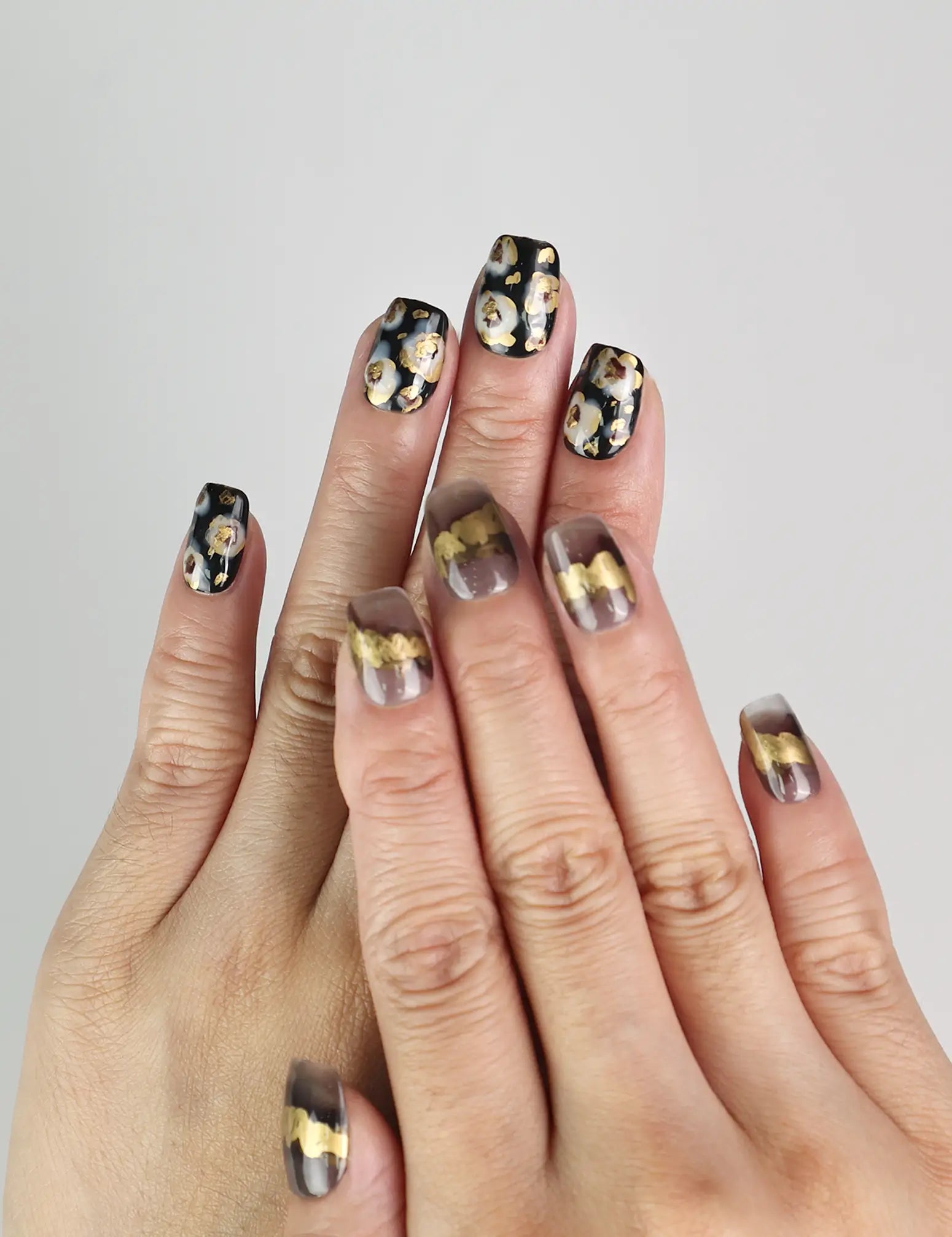 Model wearing Mystic Flow handmade press on nails with abstract swirls and metallic leaf details, bold Singapore press on nails look