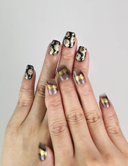 Model wearing Mystic Flow handmade press on nails with abstract swirls and metallic leaf details, bold Singapore press on nails look