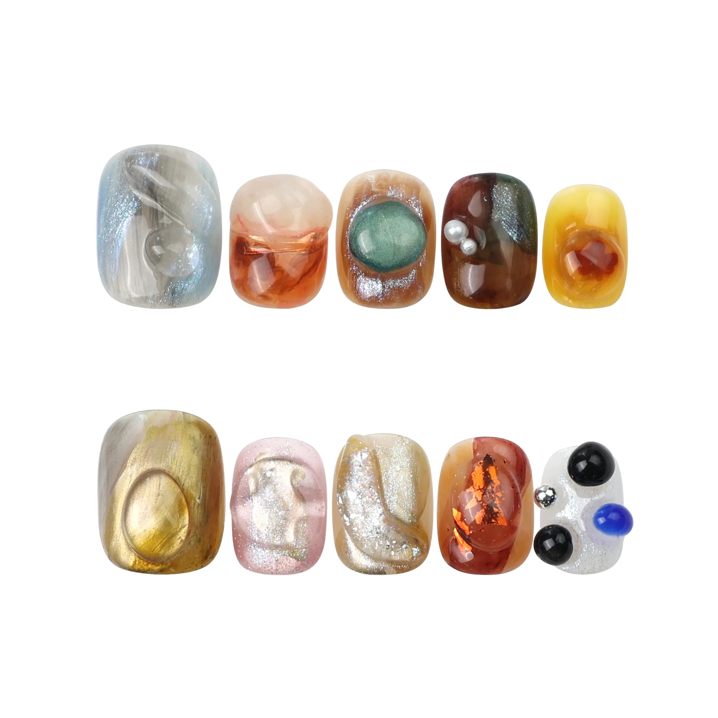 Flat-lay of Naillover Amber Whisper handmade press on nails in amber and olive shades, with a glossy finish.