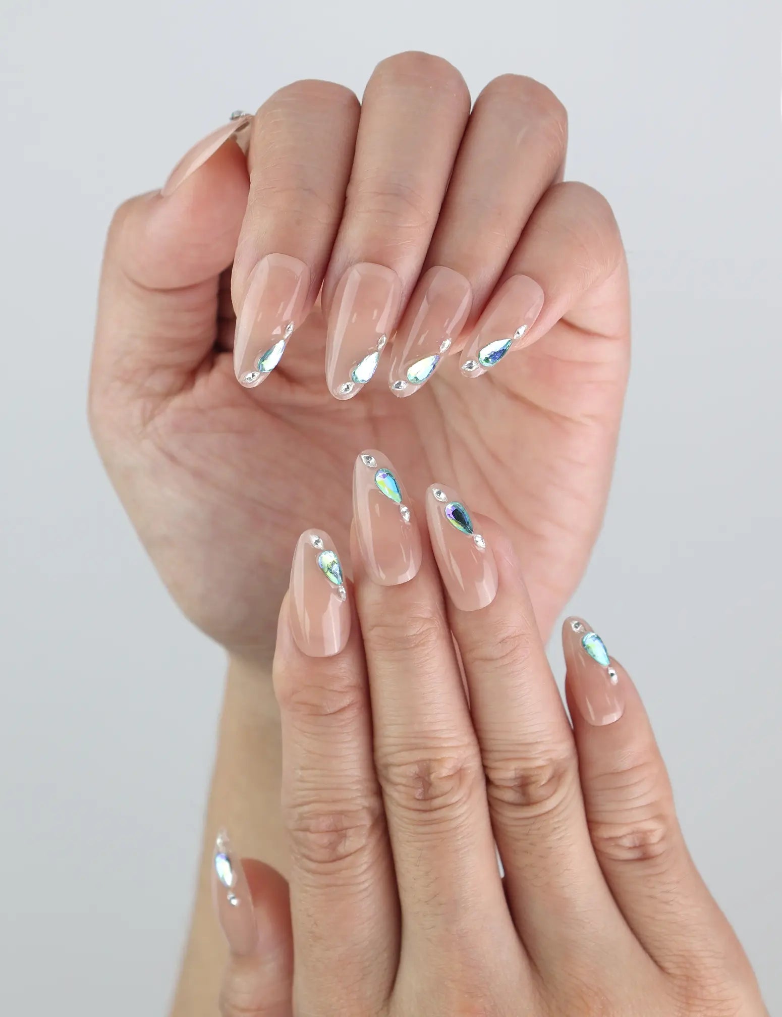 Close-up of Aqua Gem press on nails by Naillover — blue gem accents on a soft nude handmade base.