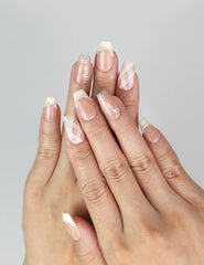 Model wearing Naillover Ballet Bow handmade Singapore press on nails with bows and pearls in pink and yellow.