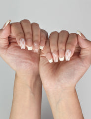 Naillover Ballet Bow handmade press on nails in soft pink and yellow shown on model’s hand.