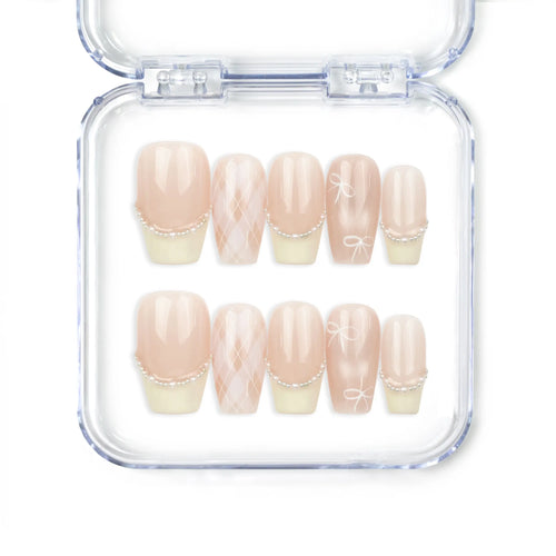 Naillover Ballet Bow handmade Singapore press on nails in soft pink and yellow with bow and pearl accents.